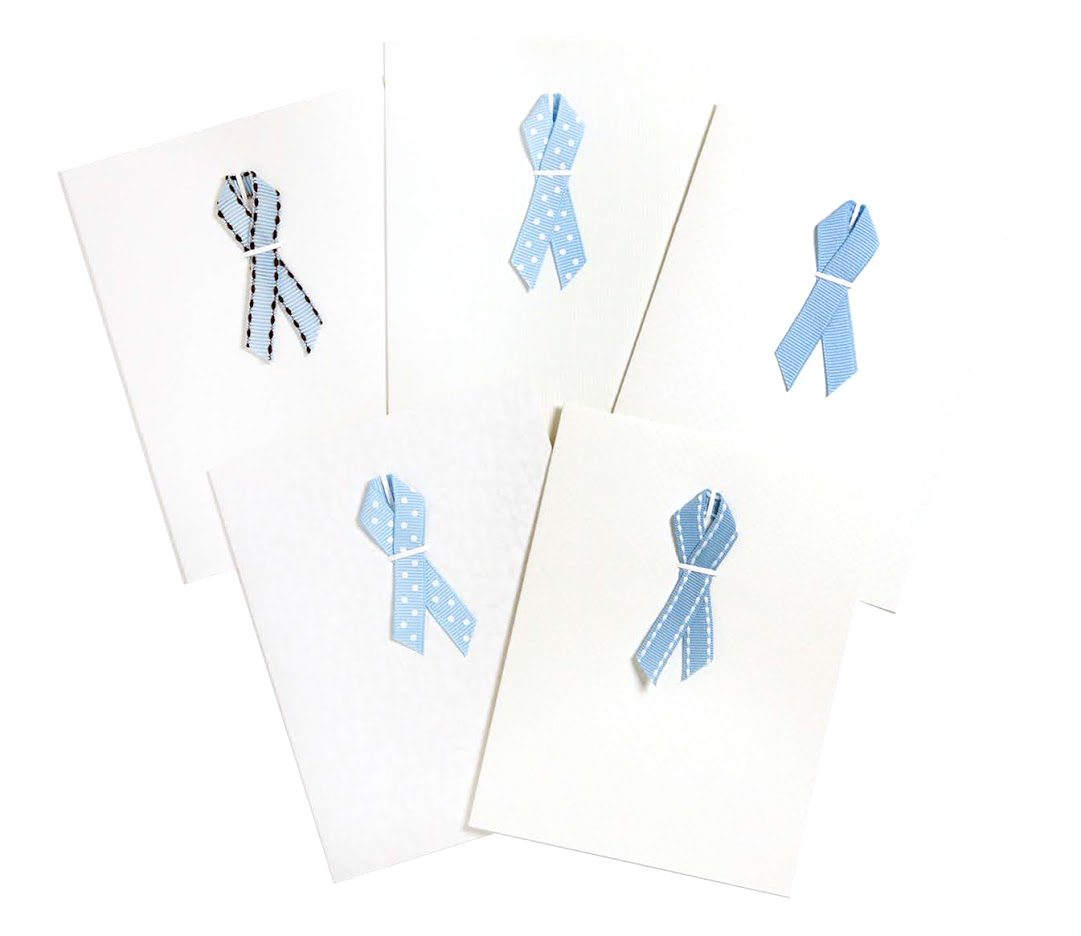 A set of five cards with blue ribbons on them.