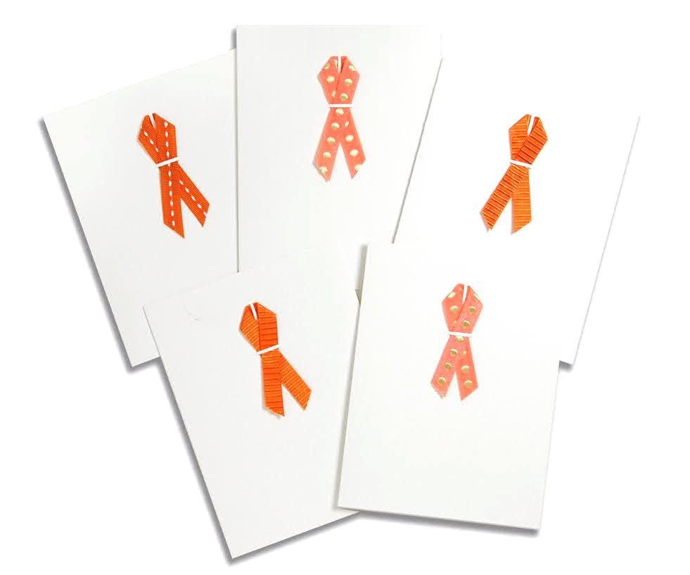 A group of cards with orange ribbons on them.