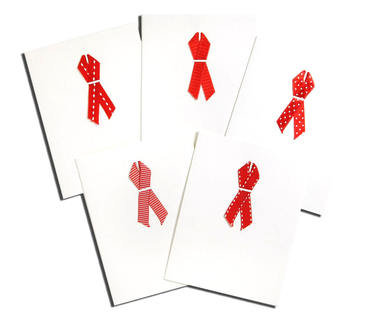 A group of cards with red ribbons on them.